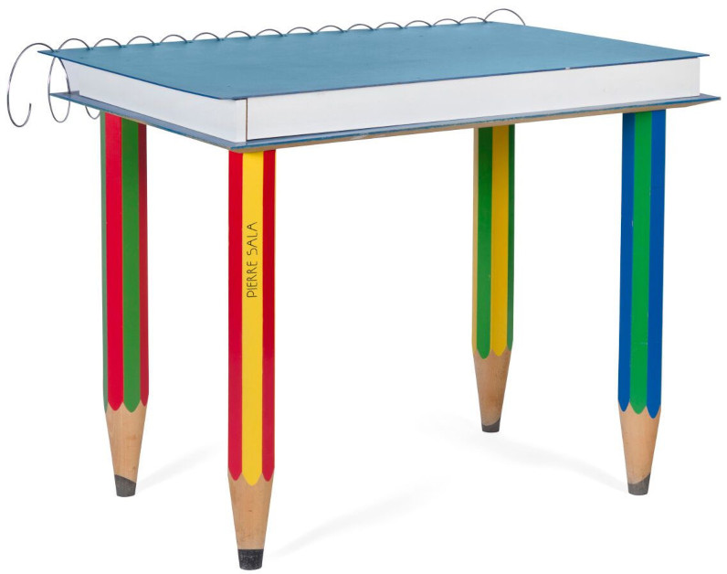 Desk shaped liked a spiral-bound book, with pencils as legs