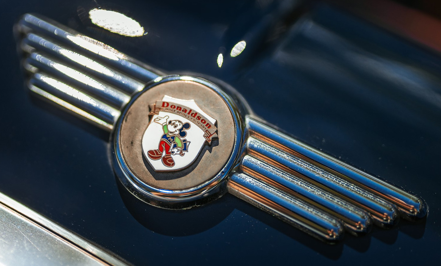 The Donaldson logo on top of the Cooper Mini emblem.