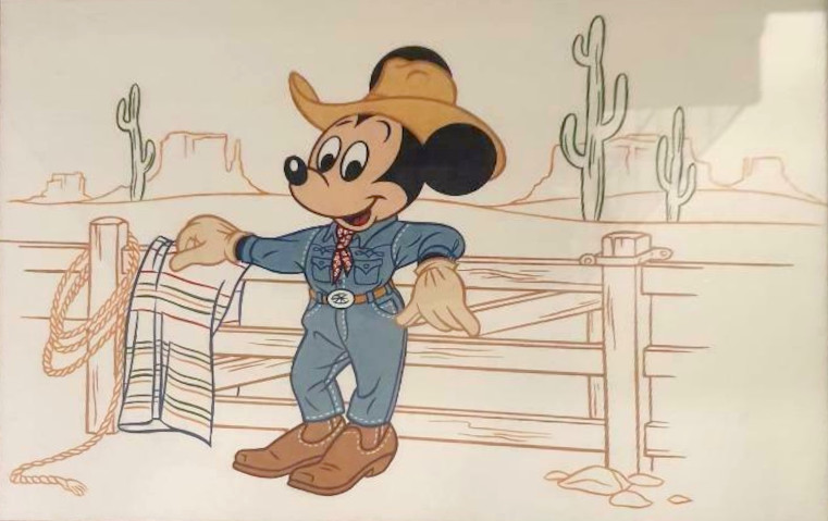Mickey is dressed as a cowboy.