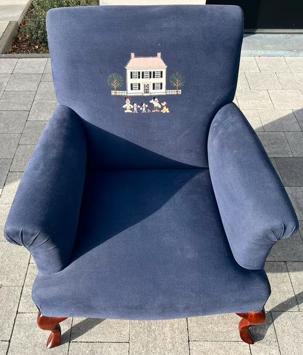 A navy blue armchair with the Donaldson house.