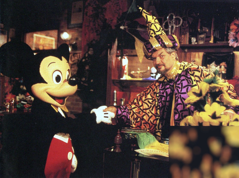 Mickey shaking hands with a sorcerer