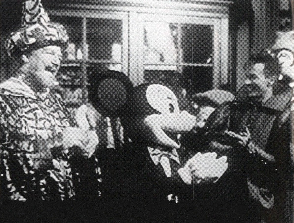 Several people and Mickey Mouse laughing