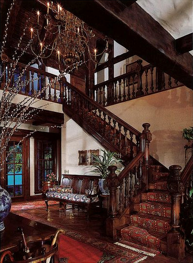 The entrance hall with a wooden staircase.