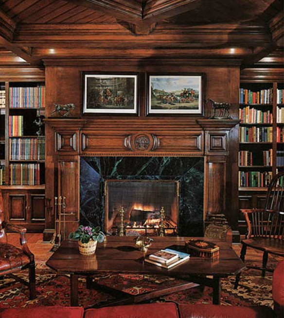 A fireplace flanked by bookcases.